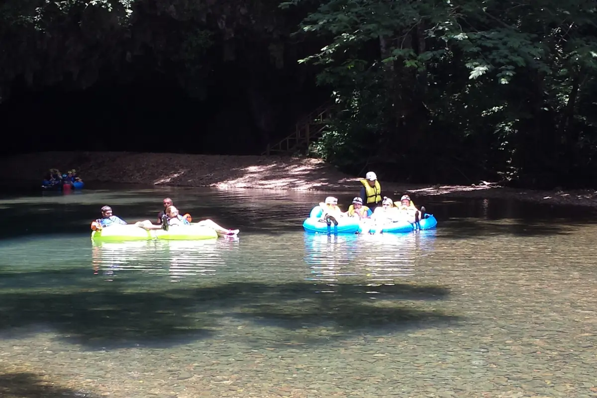 Guests paddling colorful kayaks on the river