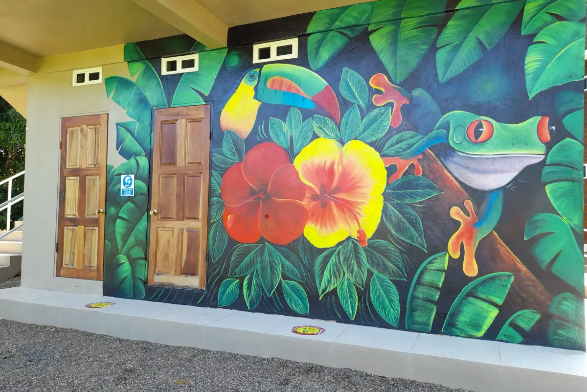 Colorful rainforest mural on an Agua Clara building