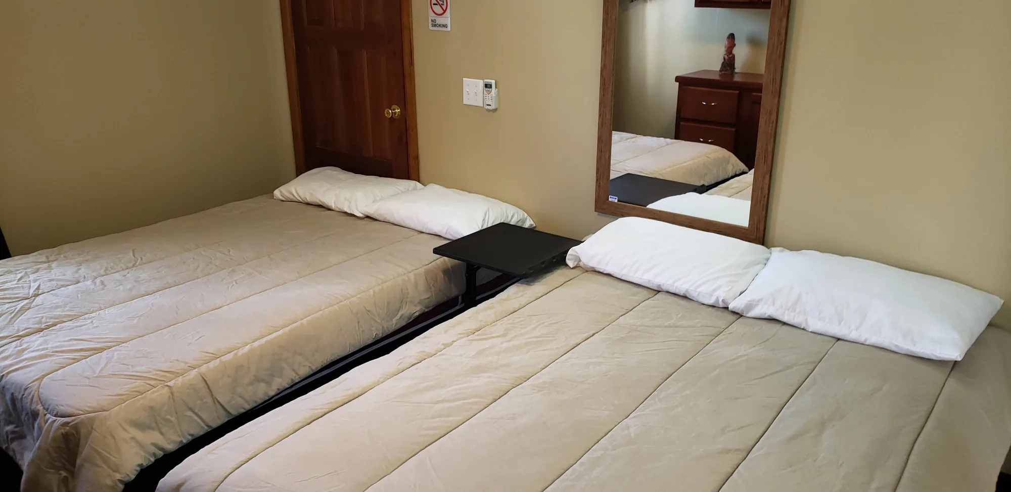 Two made double beds in the air-conditioned Tapir Suite